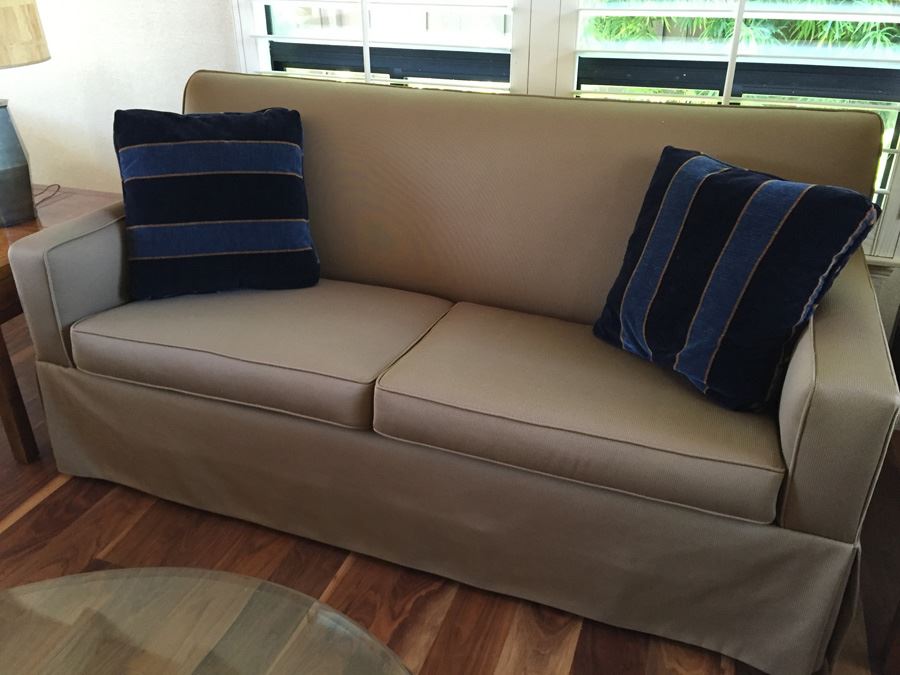 Clean Tan Sofa With Modern Lines And Two Pillows In Excellent Condition