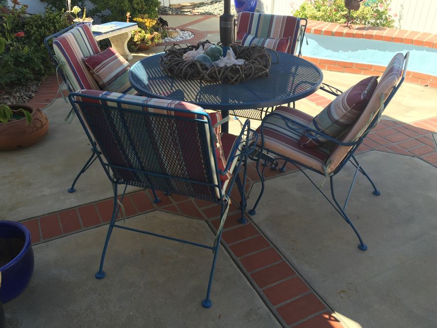 Vintage Blue Heavy Wrought Iron Patio Table With Four Chairs And Blue Umbrella [Photo 1]