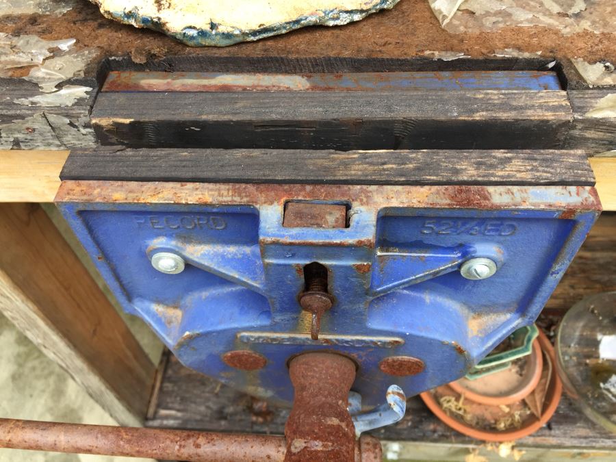 Outdoor Garden Table With Blue English Bench Vice, Various Pots And Partial Weather Vane [Photo 17]