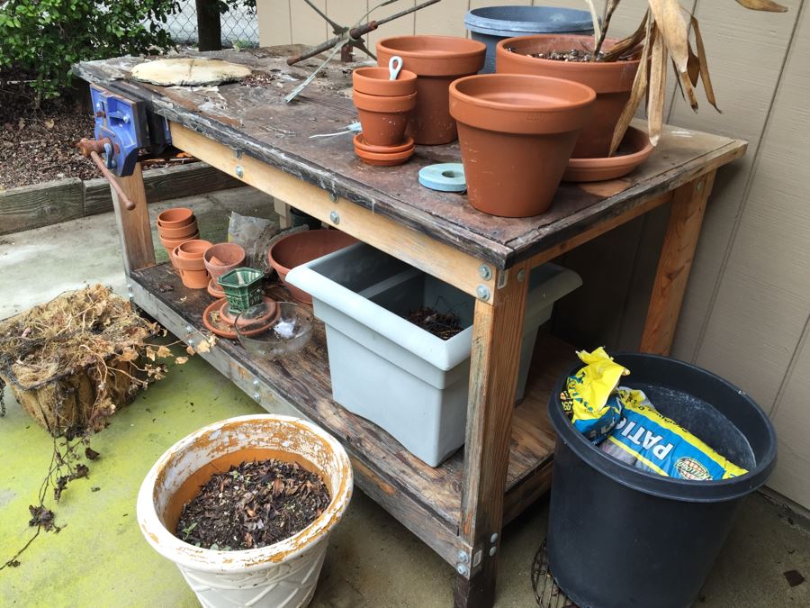 Outdoor Garden Table With Blue English Bench Vice, Various Pots And Partial Weather Vane [Photo 3]