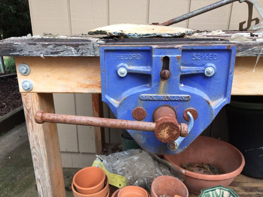 Outdoor Garden Table With Blue English Bench Vice, Various Pots And Partial Weather Vane [Photo 16]