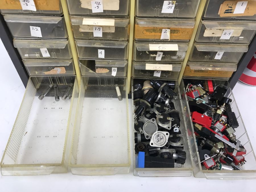 Metal Cabinet With Plastic Bins Filled With Various Fuses