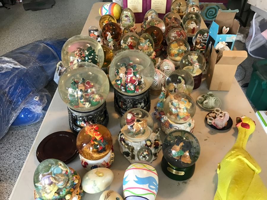 Huge Snow Globe Collection Mainly Holiday Themed Plus Decorations Featured On Table