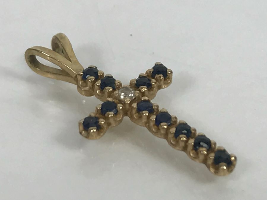 JUST ADDED - 14k Yellow Gold Cross With (11) Prong Set Saphire Like Stones And Clear Stone In Center Split Bale 3/4'L 0.5g [Photo 6]