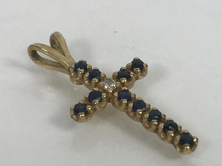 JUST ADDED - 14k Yellow Gold Cross With (11) Prong Set Saphire Like Stones And Clear Stone In Center Split Bale 3/4'L 0.5g [Photo 5]