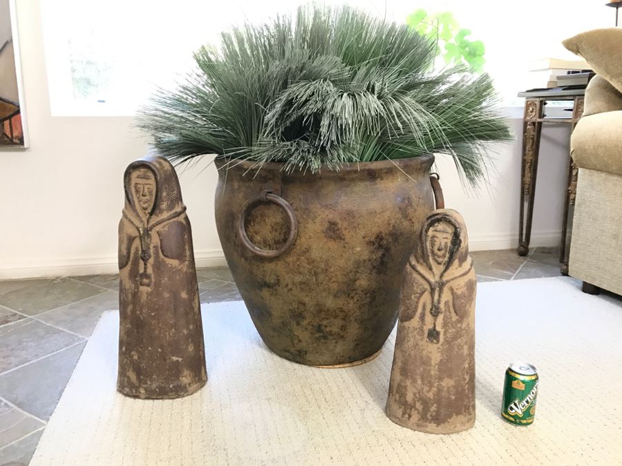 Two Large Statues And A Large Designer Pot With Metal Handles And Faux Flowers