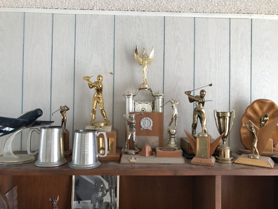 Collection Of Trophies On Top Of Cabinet