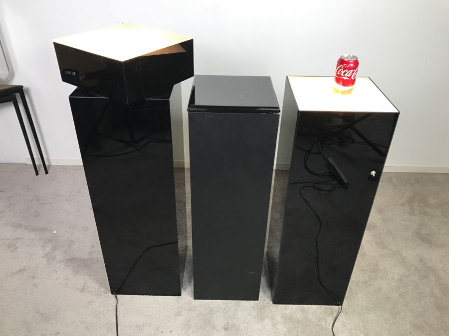 Set Of (3) Black Sculpture Pedestals - Two Light Up - One Swivels (Swiveling Pedestal Has Crack In Side Of Top) [Photo 1]