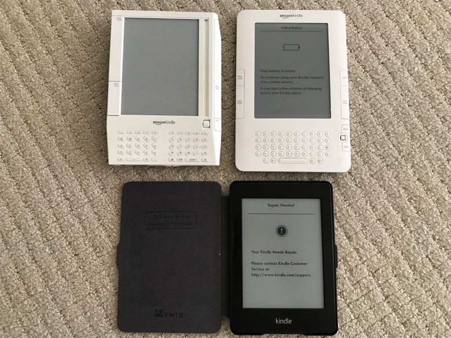 JUST ADDED - Set Of (3) Older Amazon Kindles With Vintage Kindle Case (Not Sure If Any Are Working) [Photo 1]