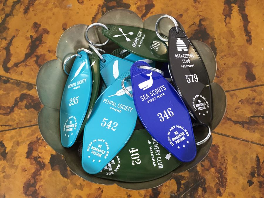 JUST ADDED - Pair Of Notepads With Clipboards, Silverplate Trophy Bowl Filled With Motel Keychains And Questionable Merit Badge Patches [Photo 2]