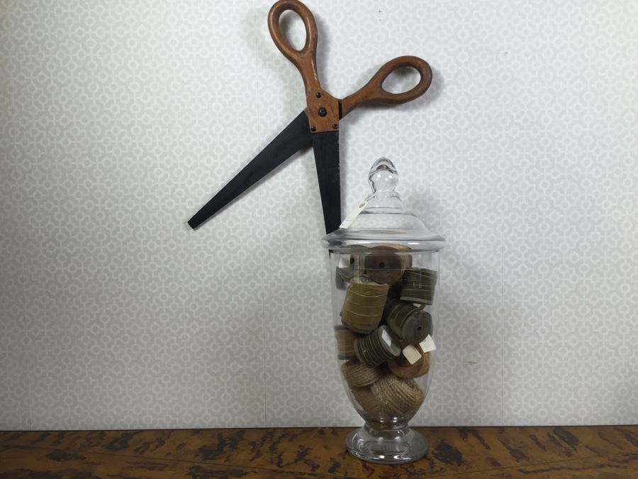 JUST ADDED - Decorative Faux Wooden Scissors, Tall Footed Glass Jar With Lid Filled With Fabric Wound Around Wooden Spools And Rope (Retails Over $400) [Photo 1]