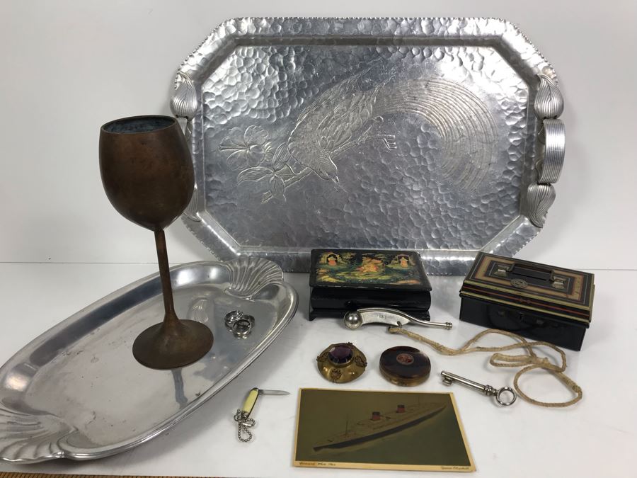 Vintage Lot Featuring An English Boatswain Whistle, Hand Wrought Bird Tray, 1946 Maiden Voyage Postcard Of Queen Elizabeth Ship, Vintage Brooch Pin, Ladies Compact, 3 Rings, Lacquer Box, Metal Box, Token, Copper Chalice And Mini Pocket Knife - See Photos [Photo 1]