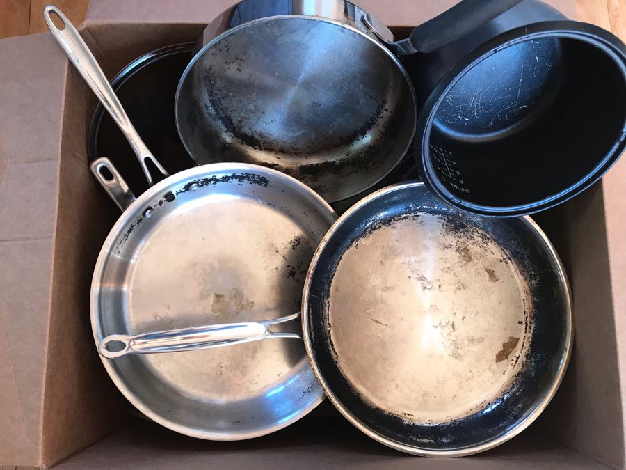 Just Added - Large Box Of Various Pots And Pans Including Lodge Cast Iron Skillet, Cuisinart Stainless Skillet, Ecolution Stainless Pots - See Photos [Photo 1]