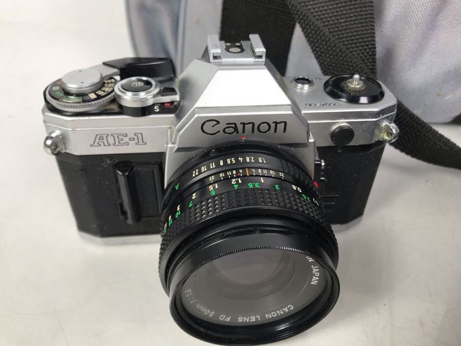 Canon AE1 Camera With Pair Of Lenses, Flash And Camera Bag