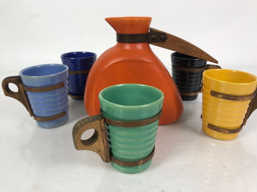 Mid-Century Modern Orange Pitcher 6.5H And Set Of (5) Colored Cups 3.5H All With Wooden And Copper Handles Unsigned Believed To Be Pacific California Pottery