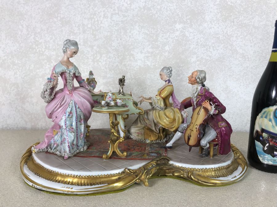 Monumental Italian Capodimonte Porcelain Figurine Of Woman Admiringly Listening To Woman Playing Piano And Man Playing Cello (See Photos For Defects) 18W X 12D X 11H [Photo 1]