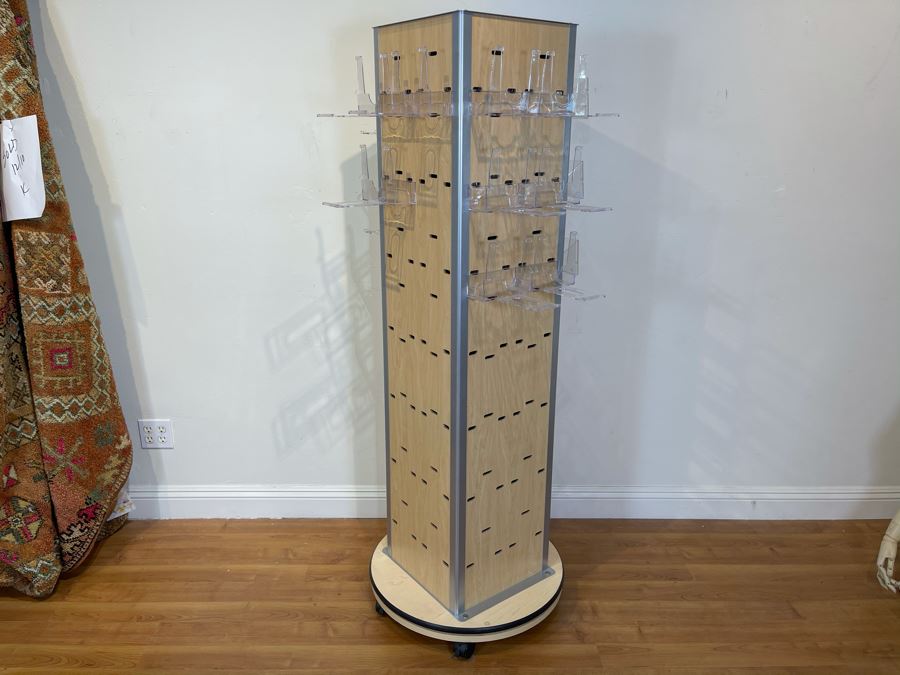 Rotating Store Display Fixture On Casters With Several Boxes Of Acrylic Product Holders 66'H X 29'D