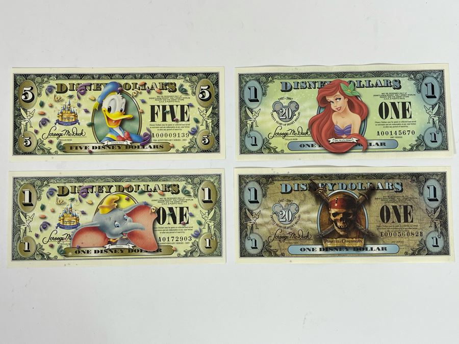 (1) Five Disney Dollars - Donald Duck, (1) One Disney Dollar - Ariel, The Little Mermaid, (1) One Disney Dollar - Pluto, (1) One Disney Dollar - Pirates Of The Caribbean