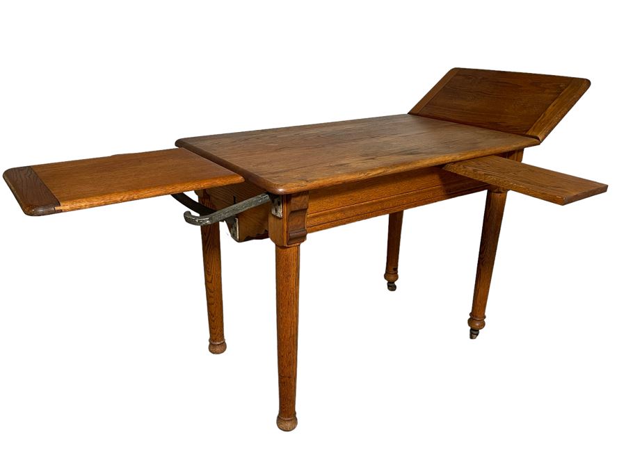 Antique Oak Doctors Medical Examiners Table Adjustable With Pair Of Metal Stirrups And Casters 41W X 24D X 29.5H [Photo 1]