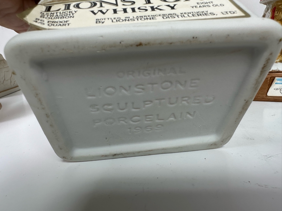 Five Porcelain Whiskey Decanters: Far Right Two Designed By C. M. Russell, Three On Left Lionstone Sculptured Porcelain 1969  Whisky 13.5H [Photo 12]