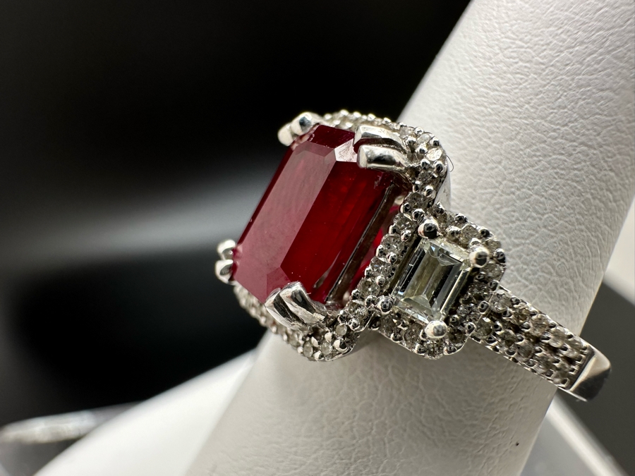14K Gold Ruby (Lead Glass Fracture Filled) Set With 34 Round Brilliant Diamonds And 2 Emerald Cut Diamonds Est. .55cttw Size 6.75 5.6g Estimated Fair Market Value: $1,200 Retail $3,600 [Photo 12]