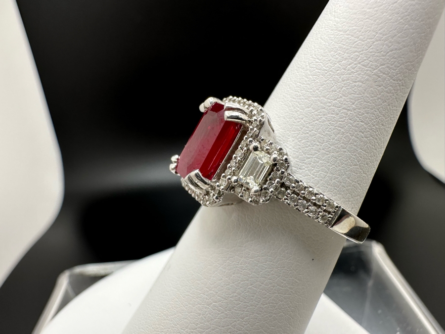 14K Gold Ruby (Lead Glass Fracture Filled) Set With 34 Round Brilliant Diamonds And 2 Emerald Cut Diamonds Est. .55cttw Size 6.75 5.6g Estimated Fair Market Value: $1,200 Retail $3,600 [Photo 10]
