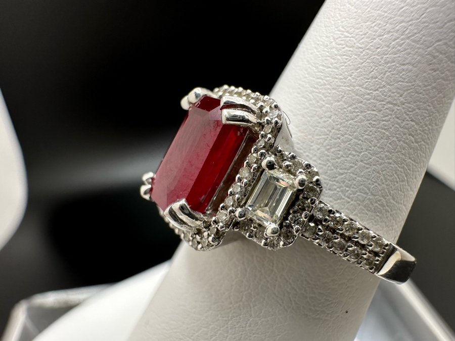 14K Gold Ruby (Lead Glass Fracture Filled) Set With 34 Round Brilliant Diamonds And 2 Emerald Cut Diamonds Est. .55cttw Size 6.75 5.6g Estimated Fair Market Value: $1,200 Retail $3,600 [Photo 11]