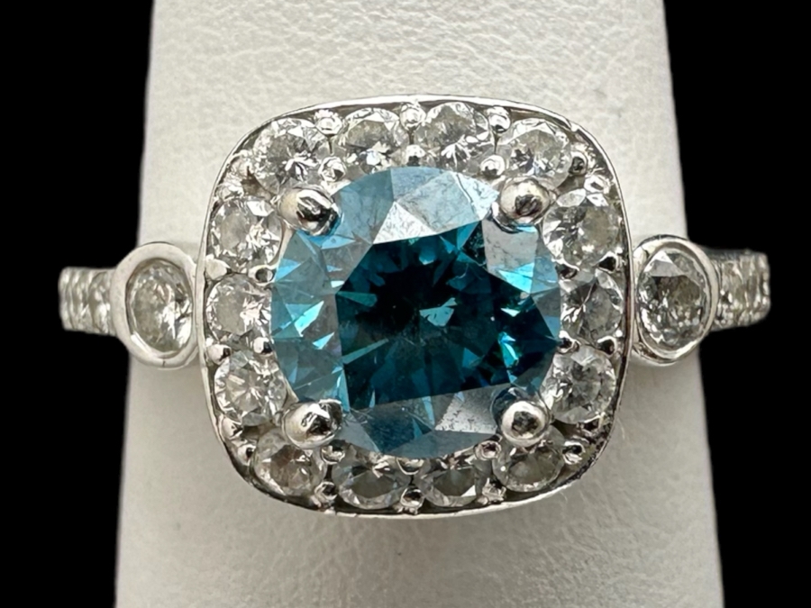 14K Gold Blue Zircon Ring Set With 25 Round Brilliant Diamonds Est. .35cttw Center Stone Blue Zircon 6.4mm X 6.4mm Est. 1cttw Size 6.5 4.8g Estimate Fair Market Value $800 Retail Value $2,400