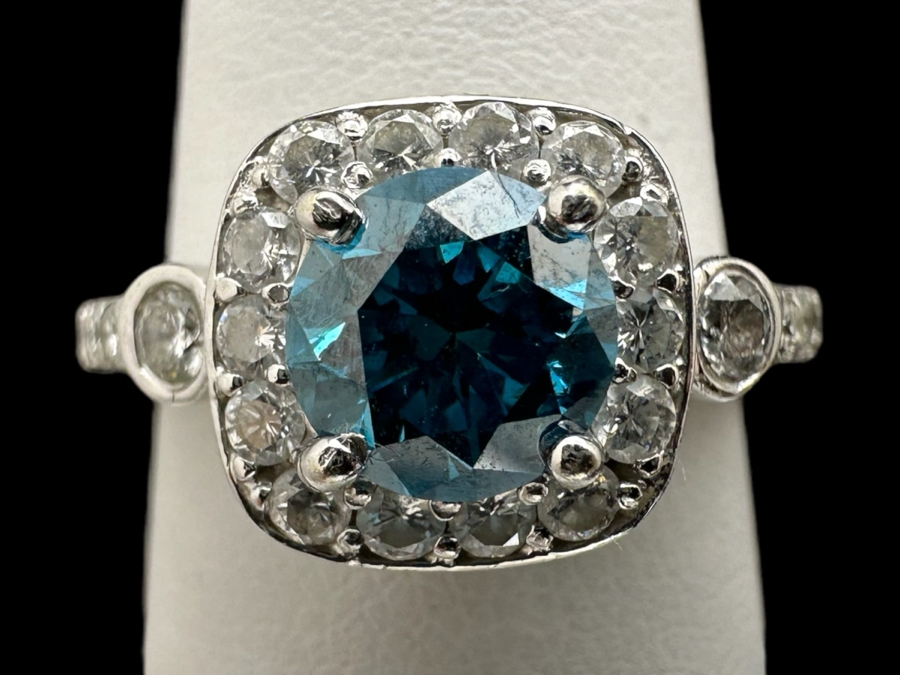 14K Gold Blue Zircon Ring Set With 25 Round Brilliant Diamonds Est. .35cttw Center Stone Blue Zircon 6.4mm X 6.4mm Est. 1cttw Size 6.5 4.8g Estimate Fair Market Value $800 Retail Value $2,400 [Photo 2]