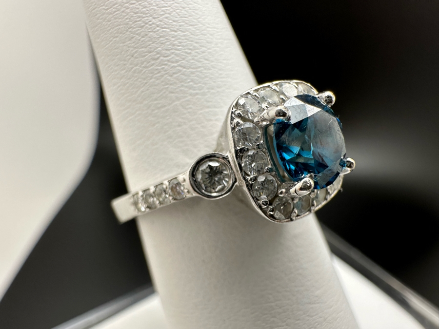 14K Gold Blue Zircon Ring Set With 25 Round Brilliant Diamonds Est. .35cttw Center Stone Blue Zircon 6.4mm X 6.4mm Est. 1cttw Size 6.5 4.8g Estimate Fair Market Value $800 Retail Value $2,400 [Photo 8]