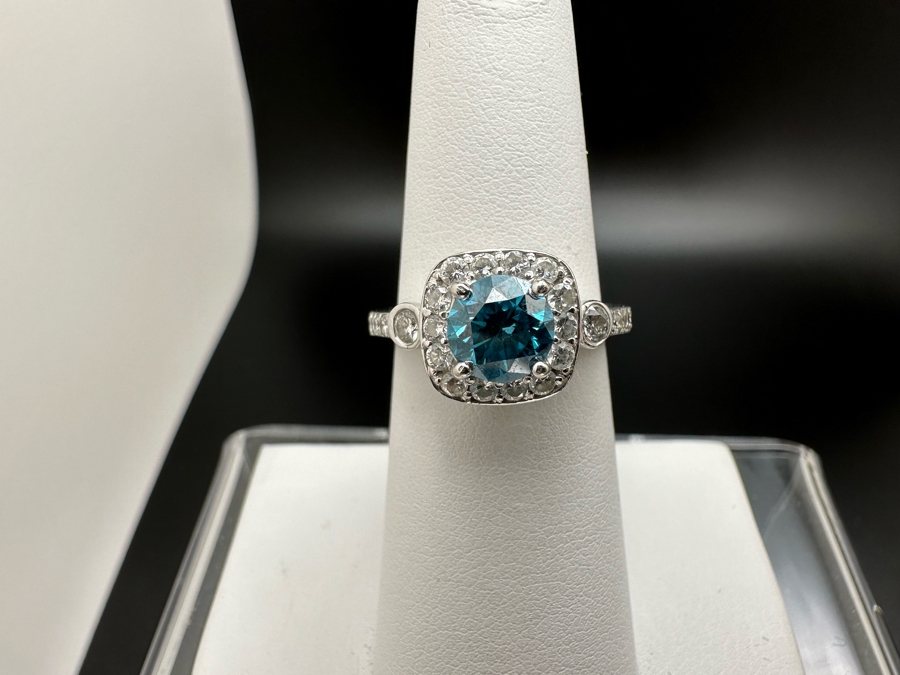 14K Gold Blue Zircon Ring Set With 25 Round Brilliant Diamonds Est. .35cttw Center Stone Blue Zircon 6.4mm X 6.4mm Est. 1cttw Size 6.5 4.8g Estimate Fair Market Value $800 Retail Value $2,400 [Photo 3]