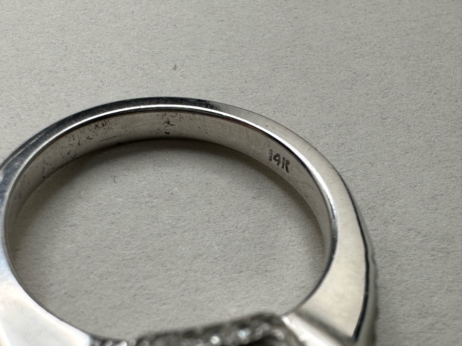 14K Gold Blue Zircon Ring Set With 25 Round Brilliant Diamonds Est. .35cttw Center Stone Blue Zircon 6.4mm X 6.4mm Est. 1cttw Size 6.5 4.8g Estimate Fair Market Value $800 Retail Value $2,400 [Photo 14]