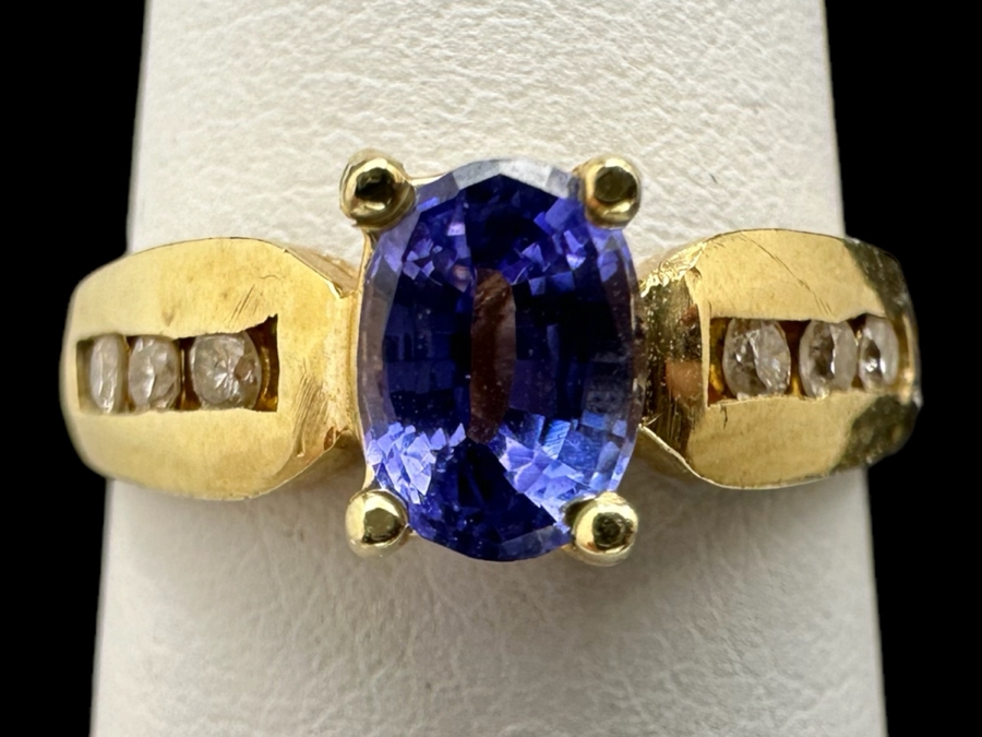 14K Gold Tanzanite Ring Set With 6 Round Brilliant Diamonds Est. .12cttw Tanzanite 6mm X 4mm 3.4g Size 6.5 Estimated Fair Market Value $500 Retail Value $1,500 [Photo 1]