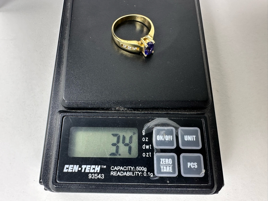 14K Gold Tanzanite Ring Set With 6 Round Brilliant Diamonds Est. .12cttw Tanzanite 6mm X 4mm 3.4g Size 6.5 Estimated Fair Market Value $500 Retail Value $1,500 [Photo 12]