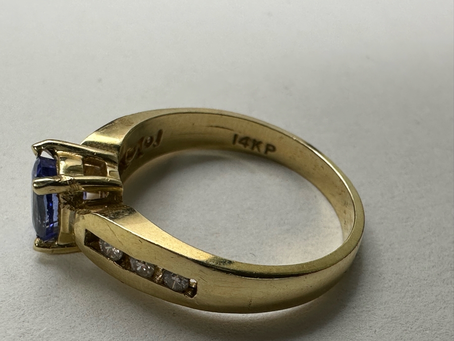 14K Gold Tanzanite Ring Set With 6 Round Brilliant Diamonds Est. .12cttw Tanzanite 6mm X 4mm 3.4g Size 6.5 Estimated Fair Market Value $500 Retail Value $1,500 [Photo 10]