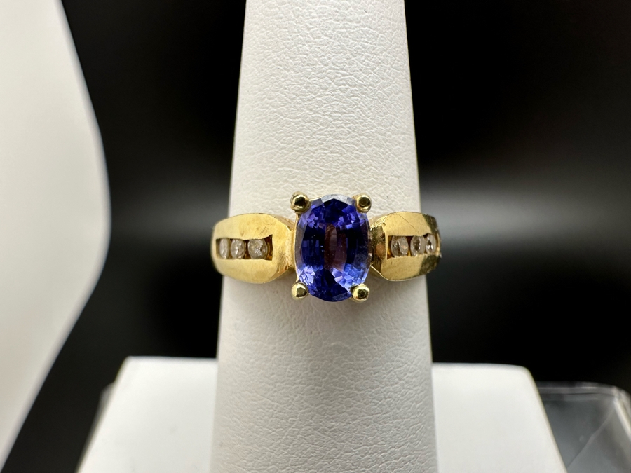 14K Gold Tanzanite Ring Set With 6 Round Brilliant Diamonds Est. .12cttw Tanzanite 6mm X 4mm 3.4g Size 6.5 Estimated Fair Market Value $500 Retail Value $1,500 [Photo 2]