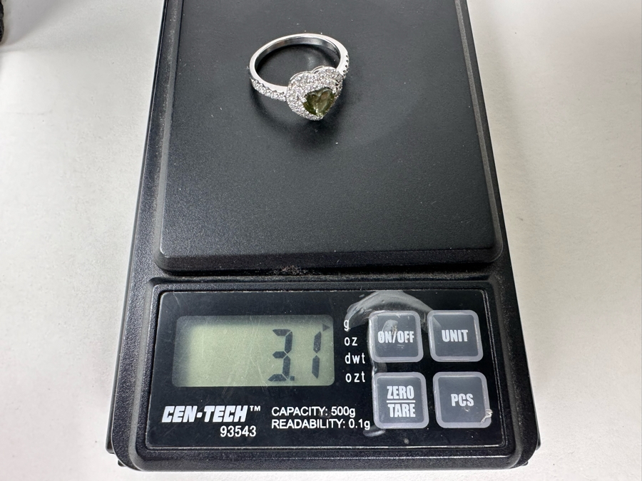 14K Gold Heart Shape Synthetic Alexanderite Ring Set With 52 Round Brilliant Diamonds Est. .40cttw Center Stone 6mm X 6mm Synthetic Alexanderite Est. 1cttw 3.1g Size 6.75 Estimated Fair Market Value $900 Retail Value $2,700 [Photo 15]