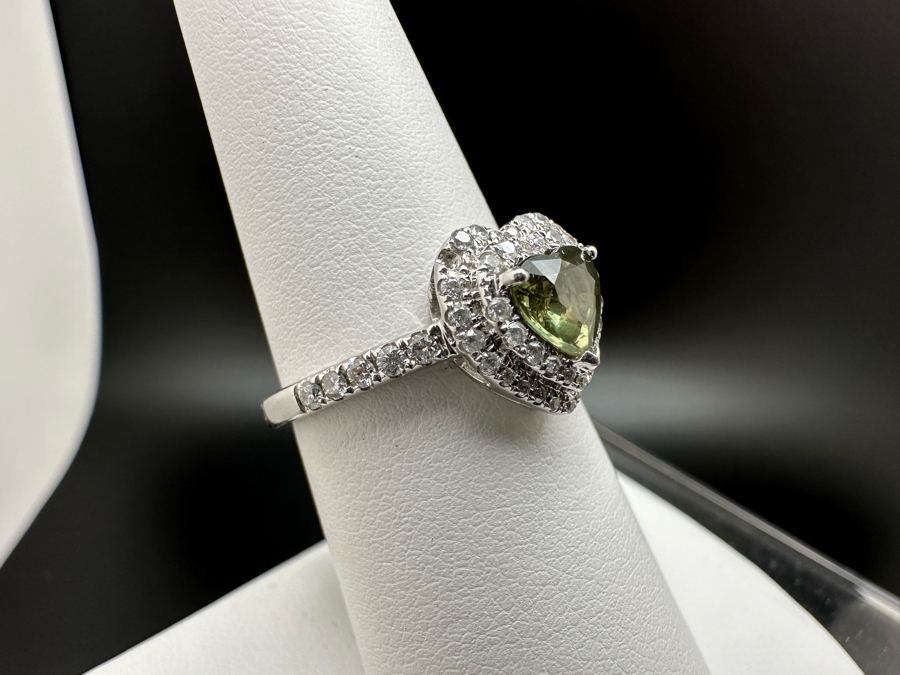 14K Gold Heart Shape Synthetic Alexanderite Ring Set With 52 Round Brilliant Diamonds Est. .40cttw Center Stone 6mm X 6mm Synthetic Alexanderite Est. 1cttw 3.1g Size 6.75 Estimated Fair Market Value $900 Retail Value $2,700 [Photo 7]