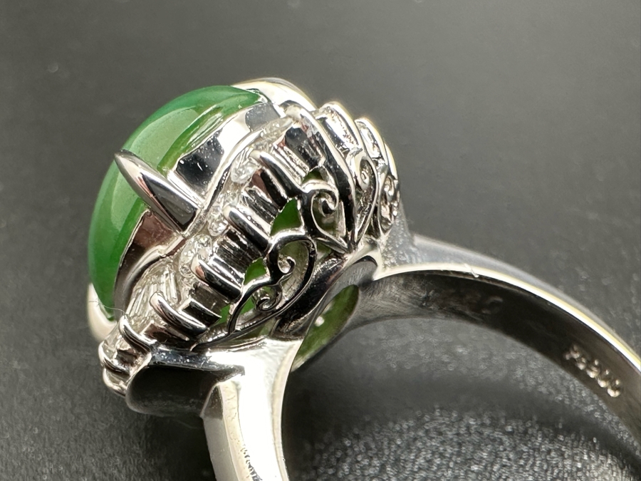 Platinum 900 Oval Green Jade 12.5mm X 9.75mm 4.6Ct Set With 14 1.5mm Round Brilliant Diamonds & 10 Tapered Baguette Diamonds Estimated .64cttw Ring Size 6.5 8.9g Estimated Value $1,675 [Photo 17]