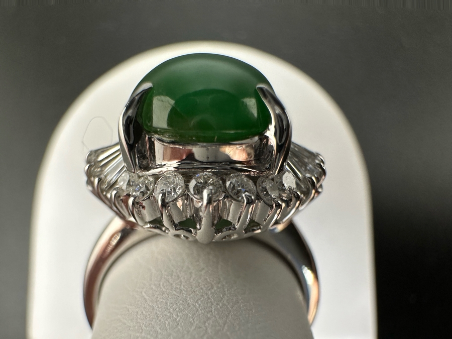 Platinum 900 Oval Green Jade 12.5mm X 9.75mm 4.6Ct Set With 14 1.5mm Round Brilliant Diamonds & 10 Tapered Baguette Diamonds Estimated .64cttw Ring Size 6.5 8.9g Estimated Value $1,675 [Photo 11]