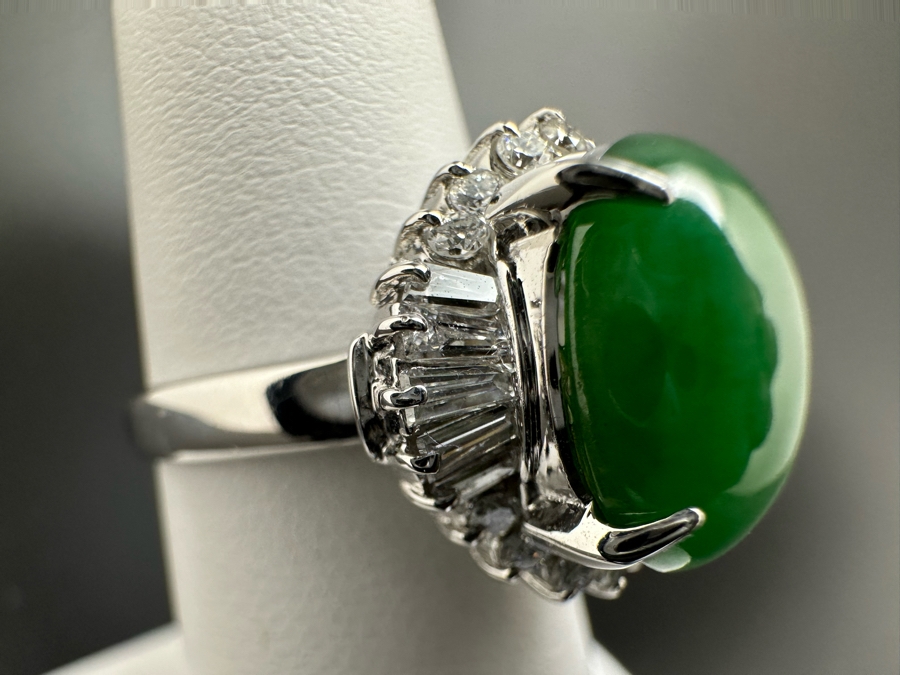 Platinum 900 Oval Green Jade 12.5mm X 9.75mm 4.6Ct Set With 14 1.5mm Round Brilliant Diamonds & 10 Tapered Baguette Diamonds Estimated .64cttw Ring Size 6.5 8.9g Estimated Value $1,675 [Photo 7]