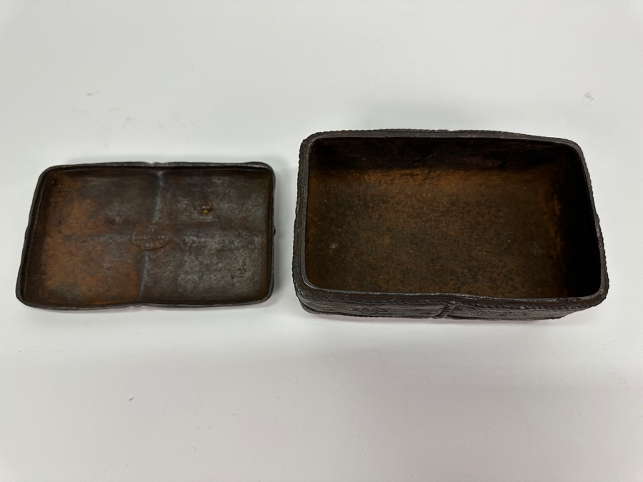 Antique Cast Iron Tobacco Jar In Shape Of A Package Wrapped With Rope Bearing An AR Star, The Number 23, The Word Piano And A Glass With Makers Mark Underneath Box [Photo 8]