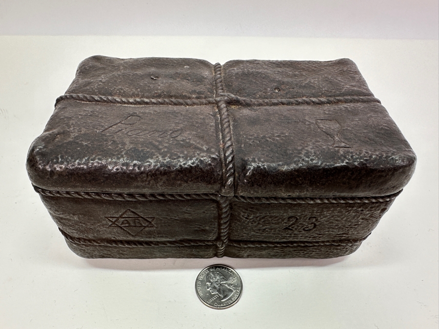 Antique Cast Iron Tobacco Jar In Shape Of A Package Wrapped With Rope Bearing An AR Star, The Number 23, The Word Piano And A Glass With Makers Mark Underneath Box [Photo 5]