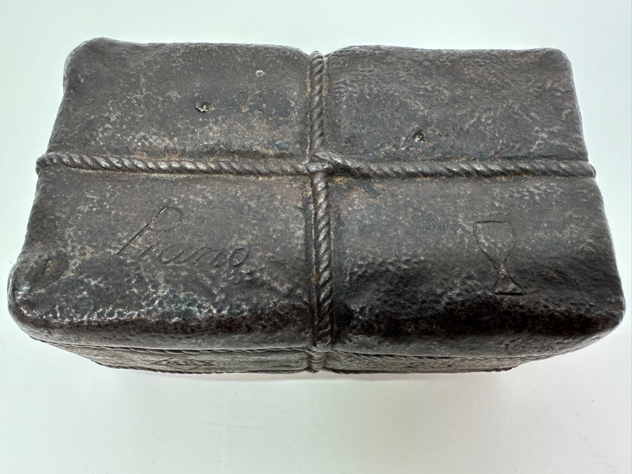 Antique Cast Iron Tobacco Jar In Shape Of A Package Wrapped With Rope Bearing An AR Star, The Number 23, The Word Piano And A Glass With Makers Mark Underneath Box [Photo 6]