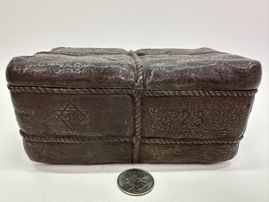 Antique Cast Iron Tobacco Jar In Shape Of A Package Wrapped With Rope Bearing An AR Star, The Number 23, The Word Piano And A Glass With Makers Mark Underneath Box [Photo 2]