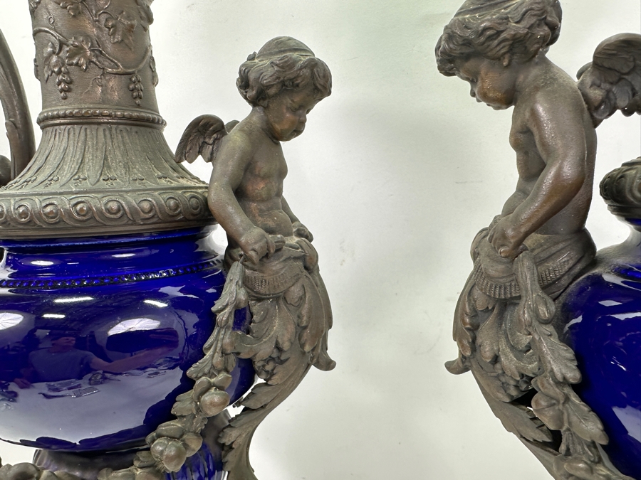 Pair Of French Decorative Ewers With Dolphin Handles And Cherub Figure - Note That A Piece Of The Metal Is Missing On One Ewer On Wooden Base 25.5'H [Photo 7]