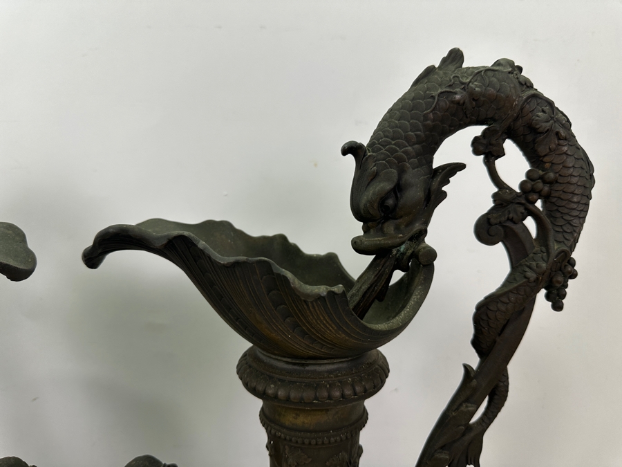 Pair Of French Decorative Ewers With Dolphin Handles And Cherub Figure - Note That A Piece Of The Metal Is Missing On One Ewer On Wooden Base 25.5'H [Photo 10]