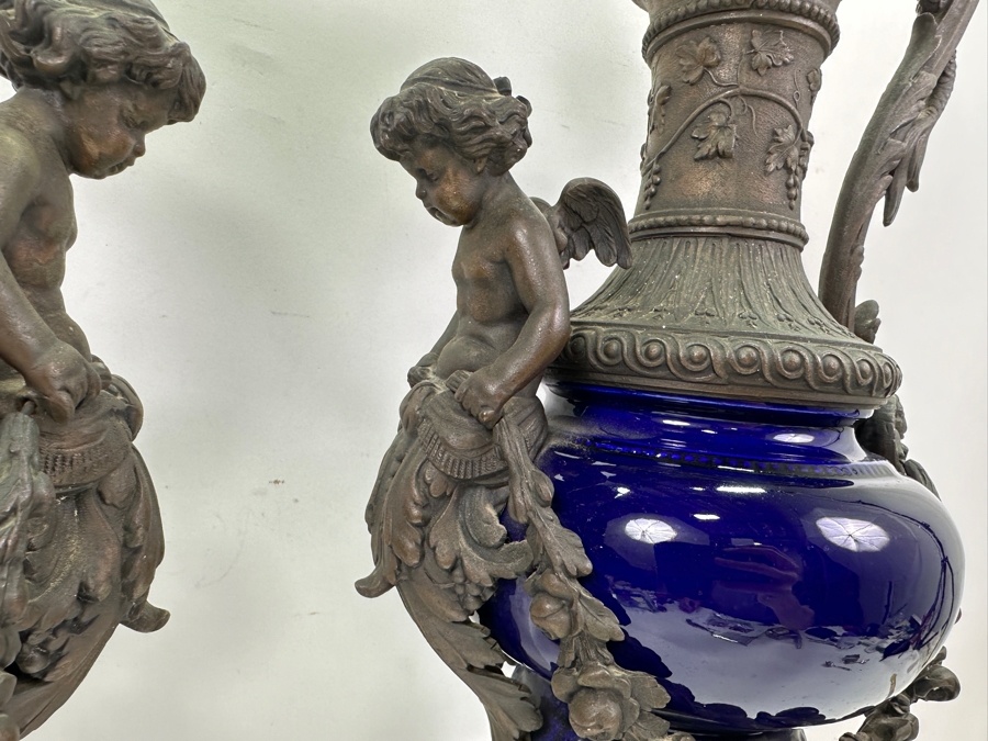 Pair Of French Decorative Ewers With Dolphin Handles And Cherub Figure - Note That A Piece Of The Metal Is Missing On One Ewer On Wooden Base 25.5'H [Photo 8]