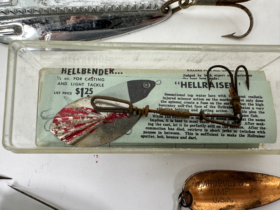 Collection Of Vintage Fishing Lures Including A Hellbender 'Hellraiser' Topwater Lure In Original Box, Johnson Silver Minnow Spoon, And Various Other Spinners And Spoons From The Mid-20th Century. 
 [Photo 13]