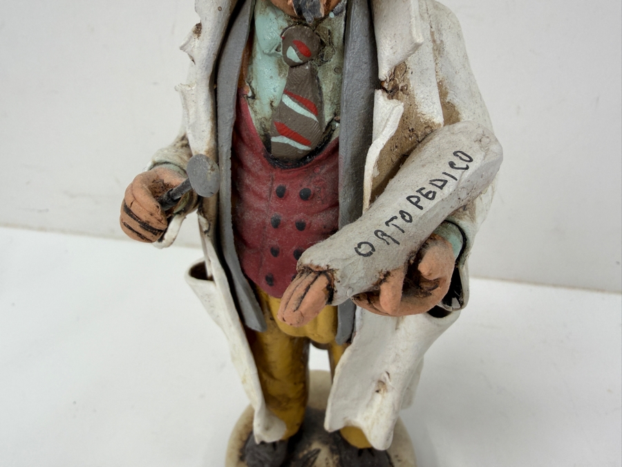 Hand Painted Pottery Sculpture Of An Orthopedic Doctor Figurine Holding Cast And Instrument Wearing Lab Coat And Striped Tie With Ortopedico Label 8.5'H [Photo 2]